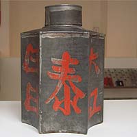 Exceptionally formed tea tin with asian characters